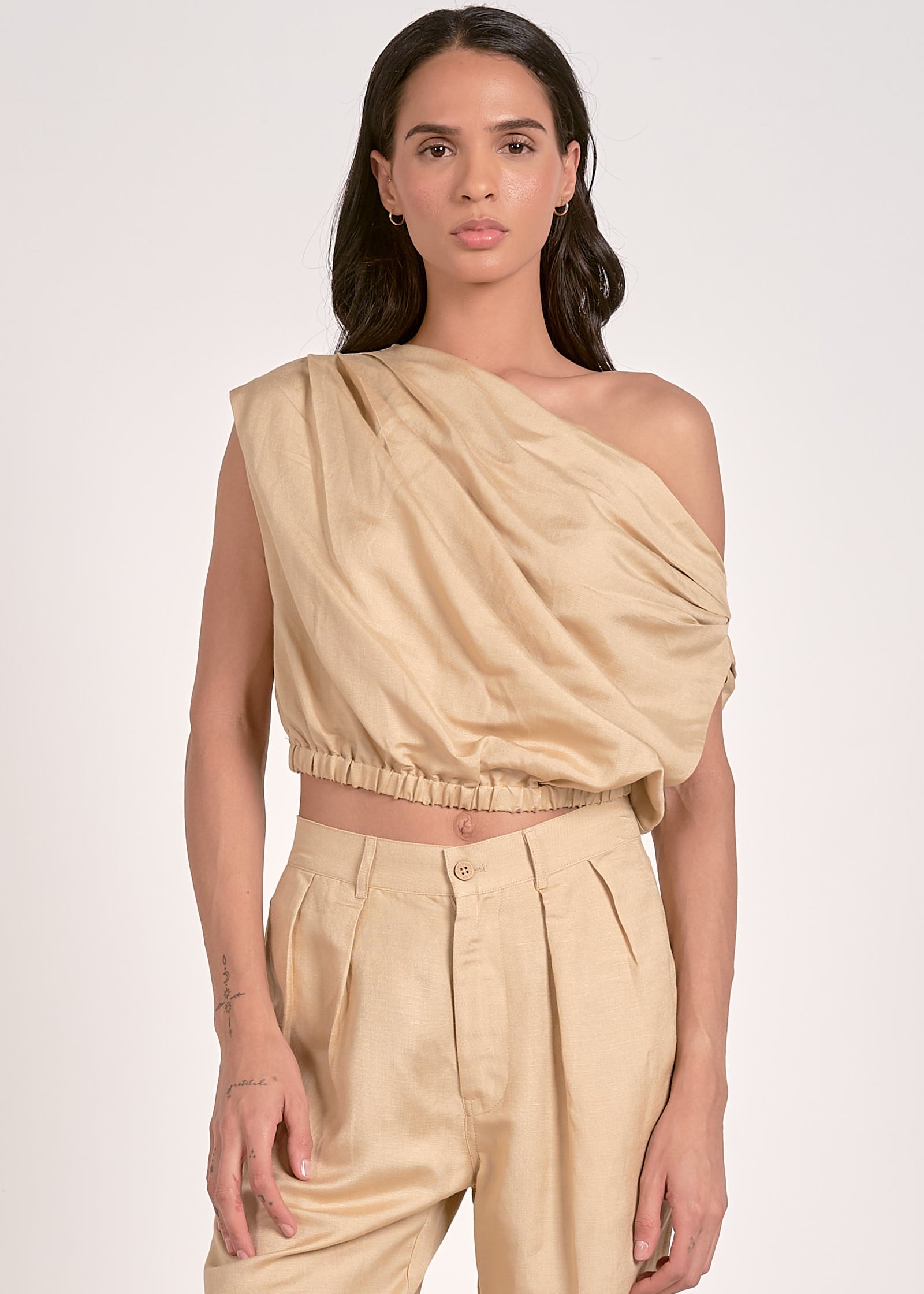 Khaki two piece set. One shoulder top with matching high-waisted pleated front pants.