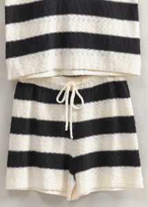 The Sun Is Out, So Slip Into This Set And Head Out. Covered In A Striped Pattern, The Sweater Top Has A V-Neckline With A Sleeveless Bodice That Has A Relaxed Fit. The Matching Shorts Have A Drawstring Waist And A Flowy Silhouette.