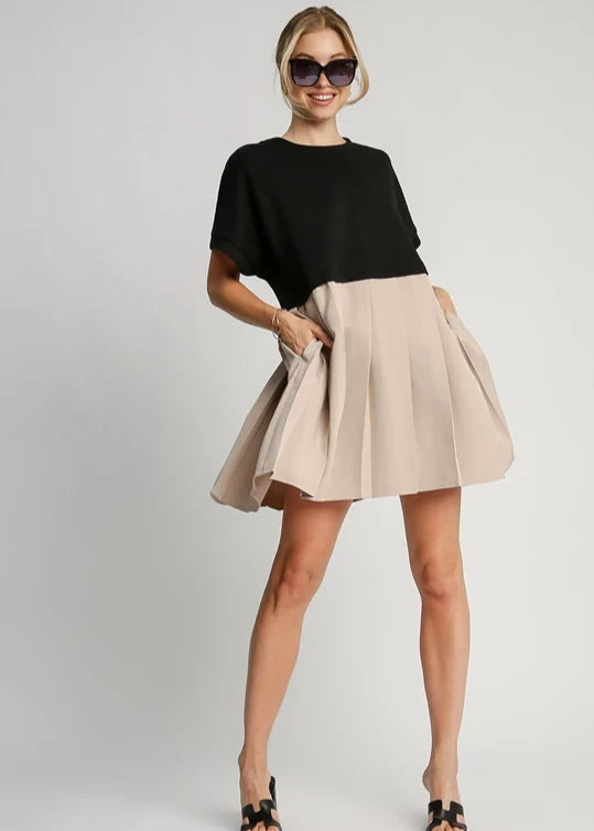 Black and oatmeal round neck knit skirt dress.Jacquard. Pleated skirt. Side pockets.