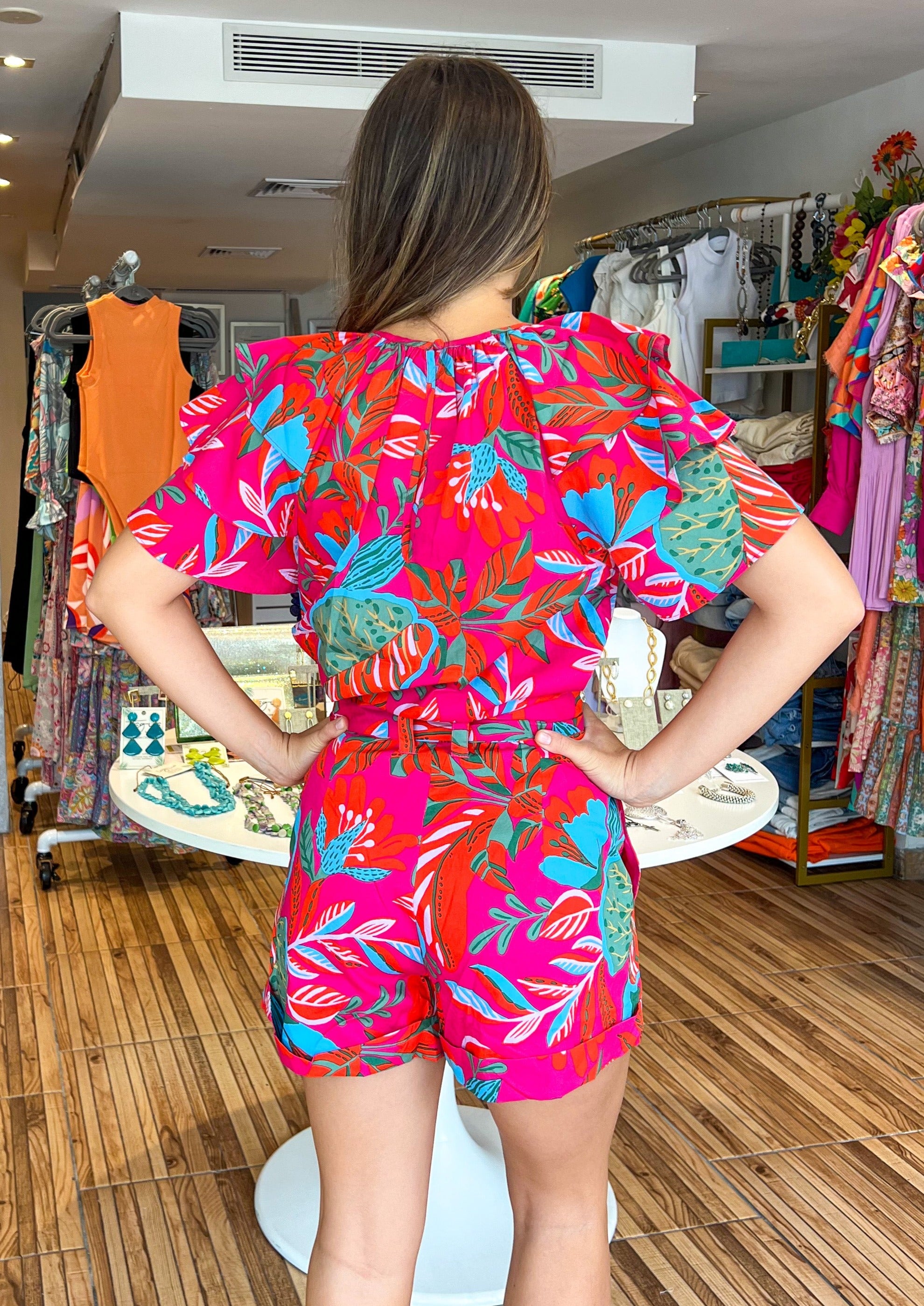 Have some fun in the sun in the Cactus Blossom Blouse. Decorated with a mix of vibrant florals.It features a classic round neckline framed by dolman ruffle layered sleeves. It maintains a straight frame and can be styled tucked in. Take on the summer in these vibrant, mixed floral print shorts. Made of a lightweight and breathable cotton fabric, the shorts sit high on the waist with a self tie belt. They maintain a comfortable loose fit throughout the hips and legs.