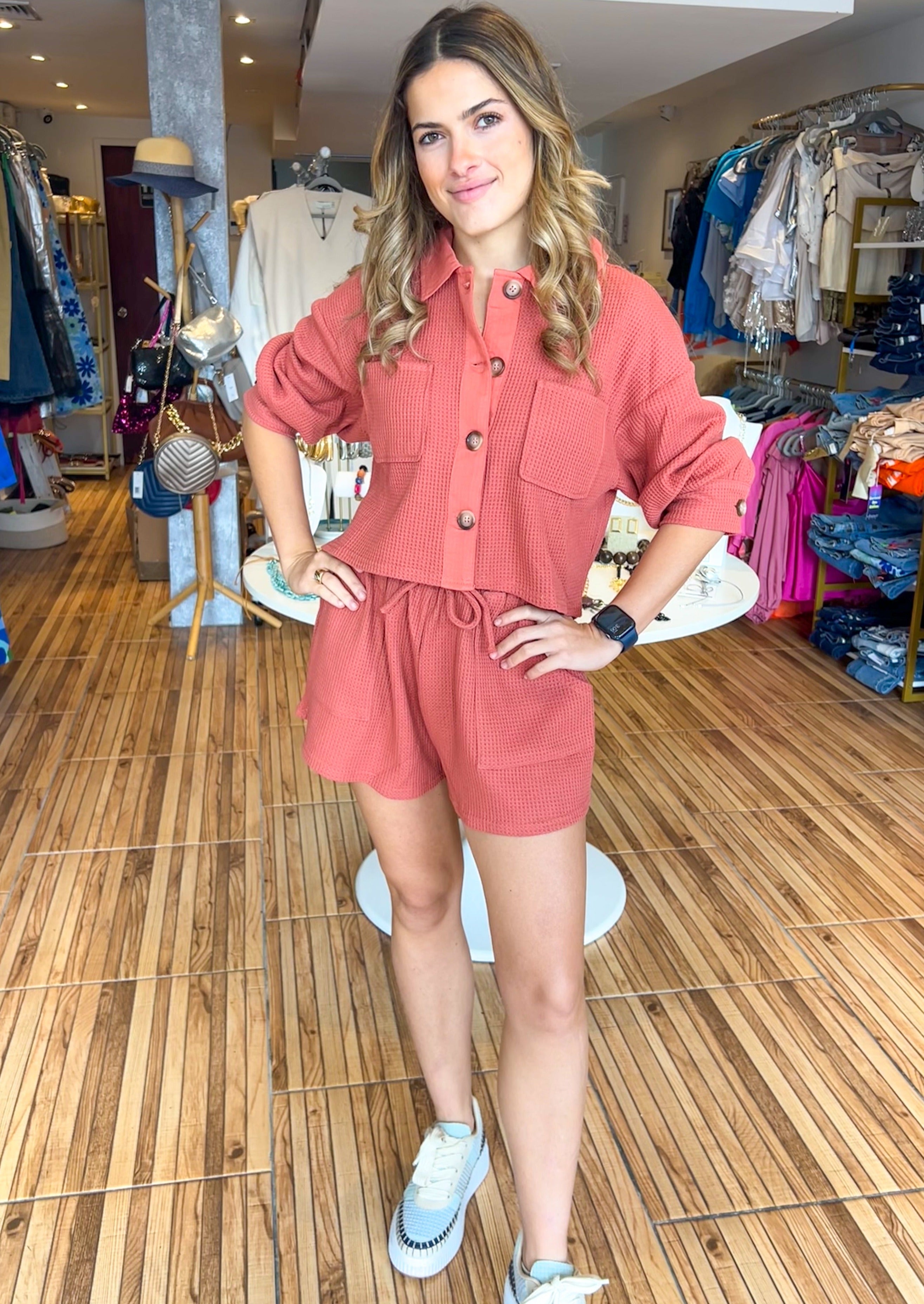 Two piece set. Waffle texture high waisted short with side pockets with matching button up top with two front pockets and 3/4 length sleeves.