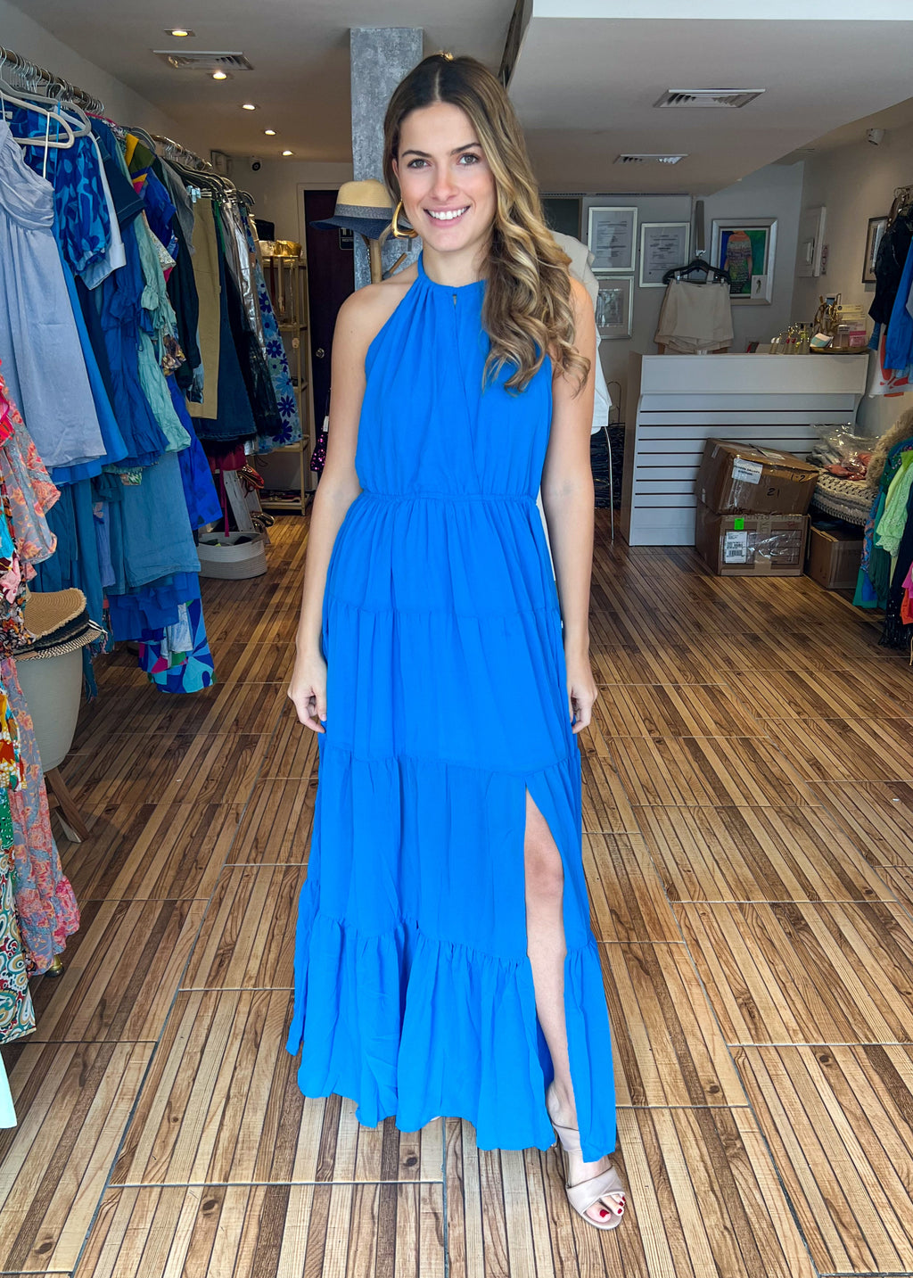 Ocean sleeveless tiered maxi dress with side slit and waist bow tie.
