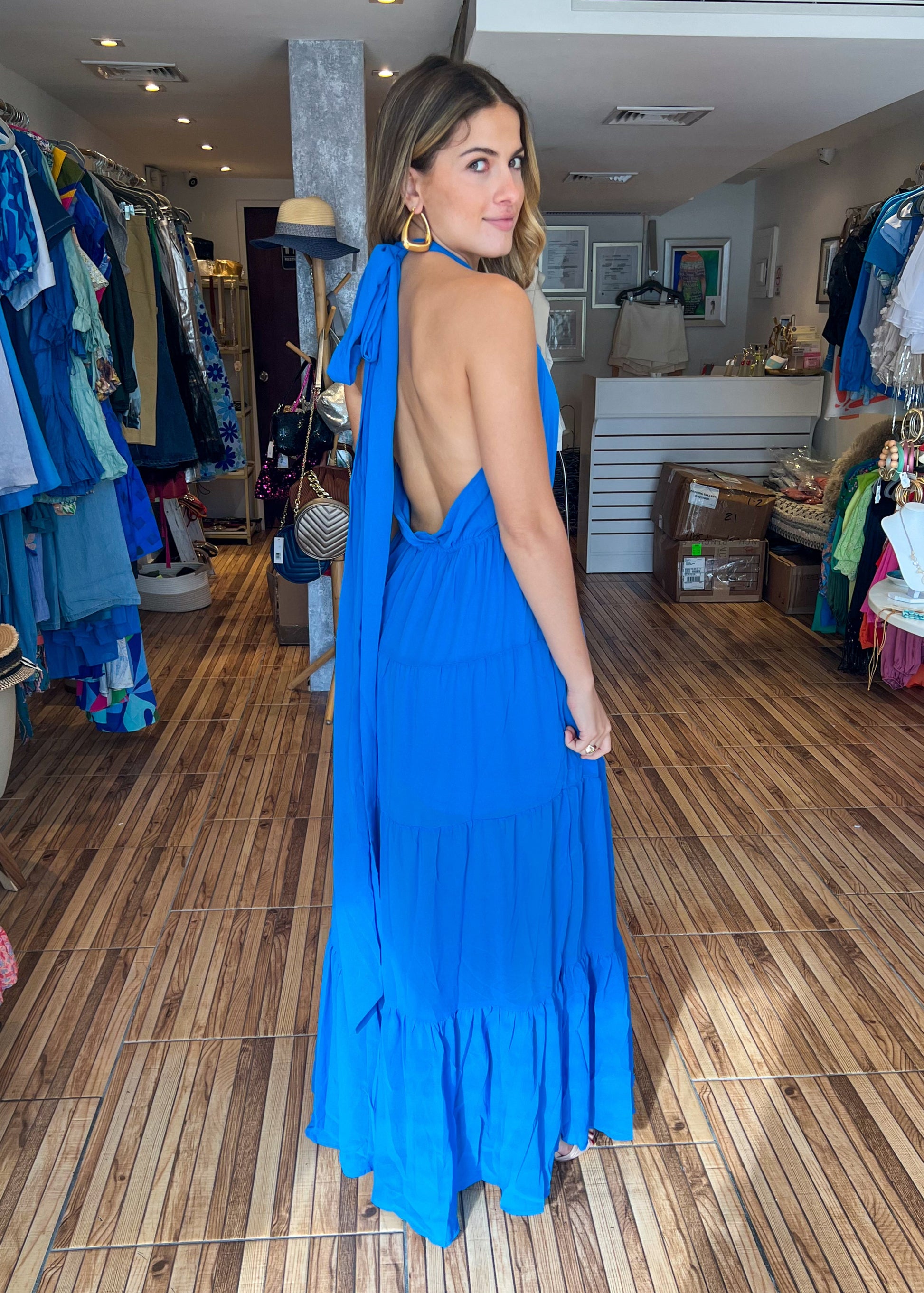 Ocean sleeveless tiered maxi dress with side slit and waist bow tie.