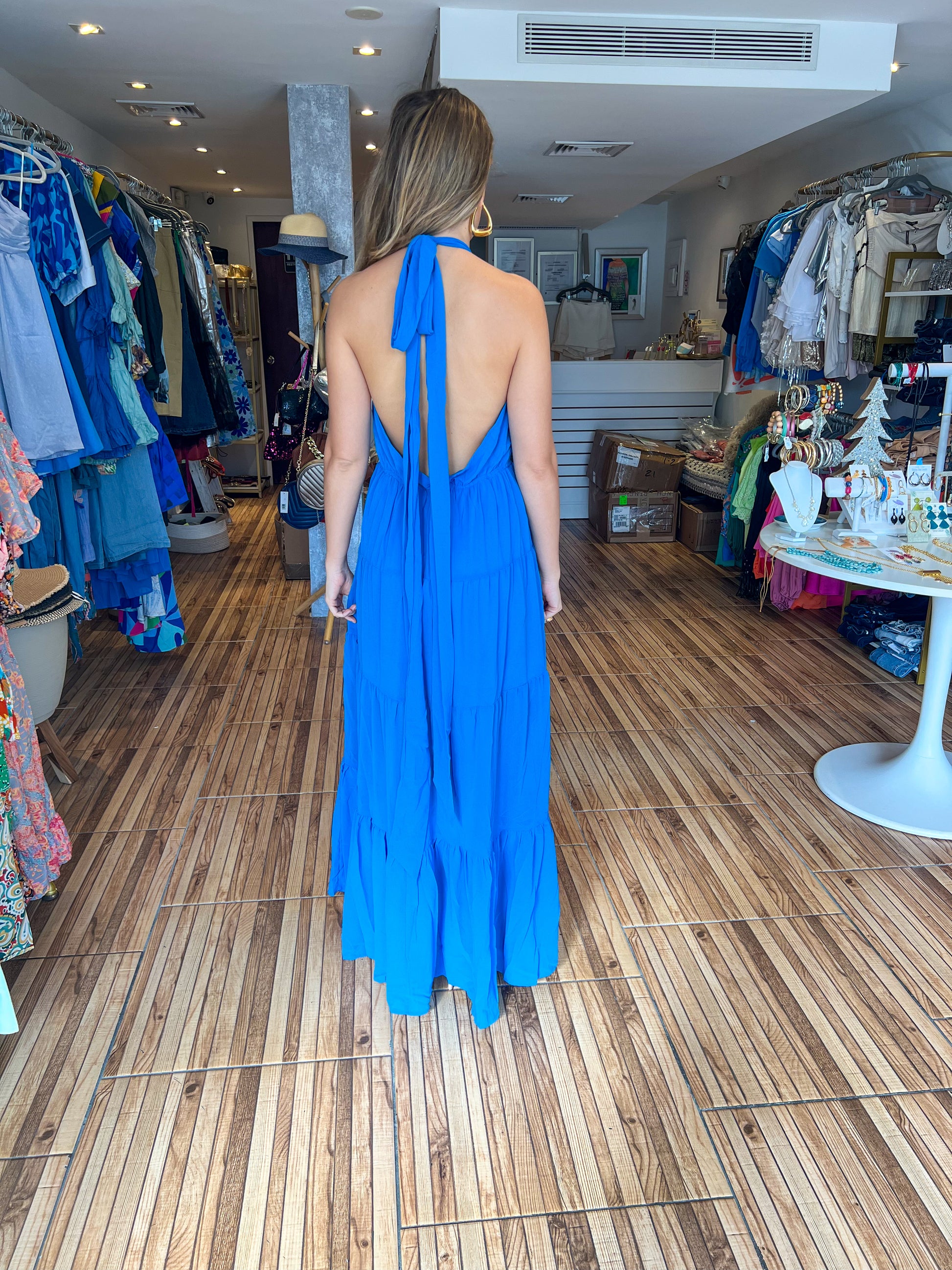 Ocean sleeveless tiered maxi dress with side slit and waist bow tie.