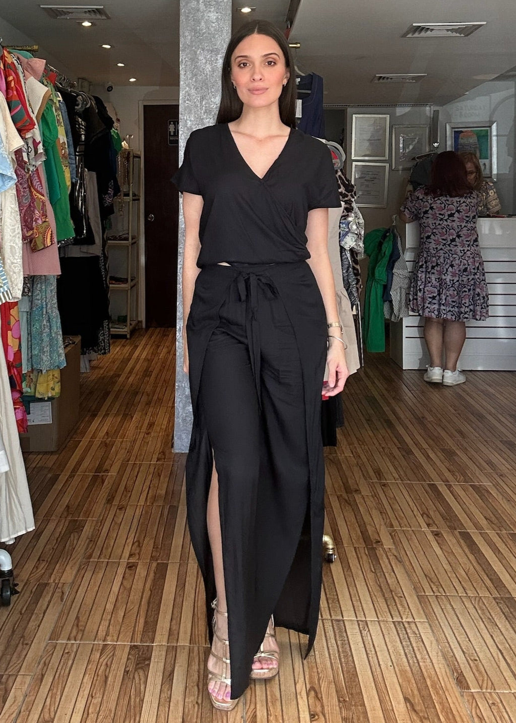 Black two piece set. Short sleeve v-neck top with matching high waisted wrap around pants.