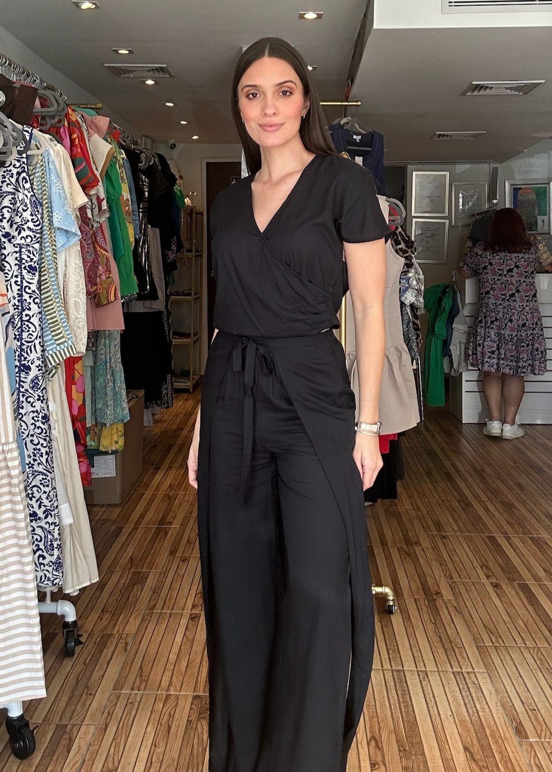 Black two piece set. Short sleeve v-neck top with matching high waisted wrap around pants.