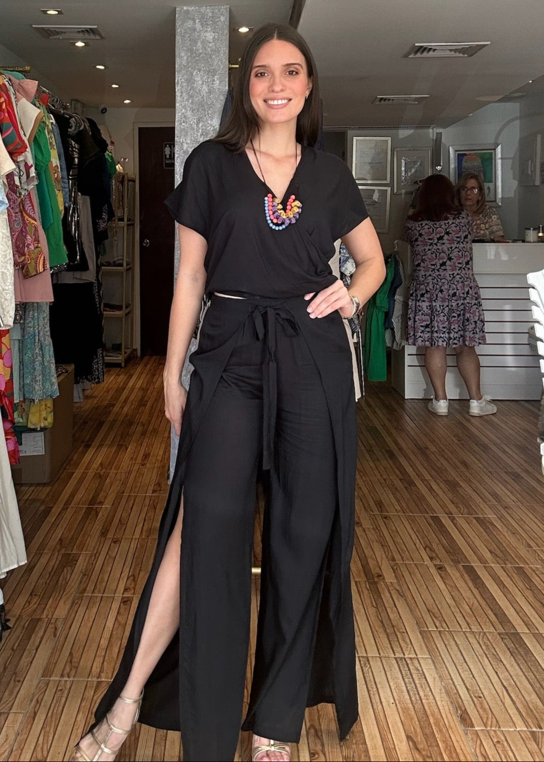 Black two piece set. Short sleeve v-neck top with matching high waisted wrap around pants.