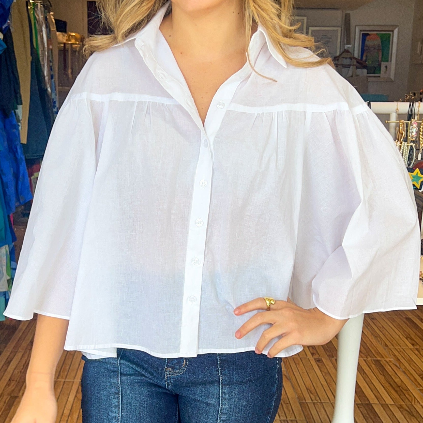 Loose fitting bell sleeve button down blouse. Available in pink and white.