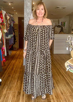 Load image into Gallery viewer, Cream and black off the shoulder maxi dress with pockets.
