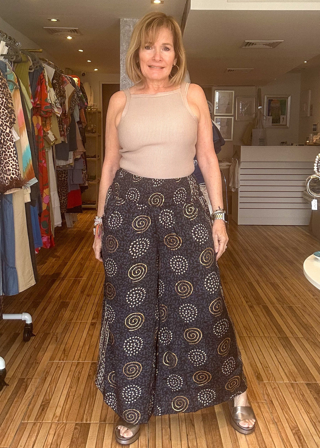 Black and gold printed loose fitting pants with stretch waist.