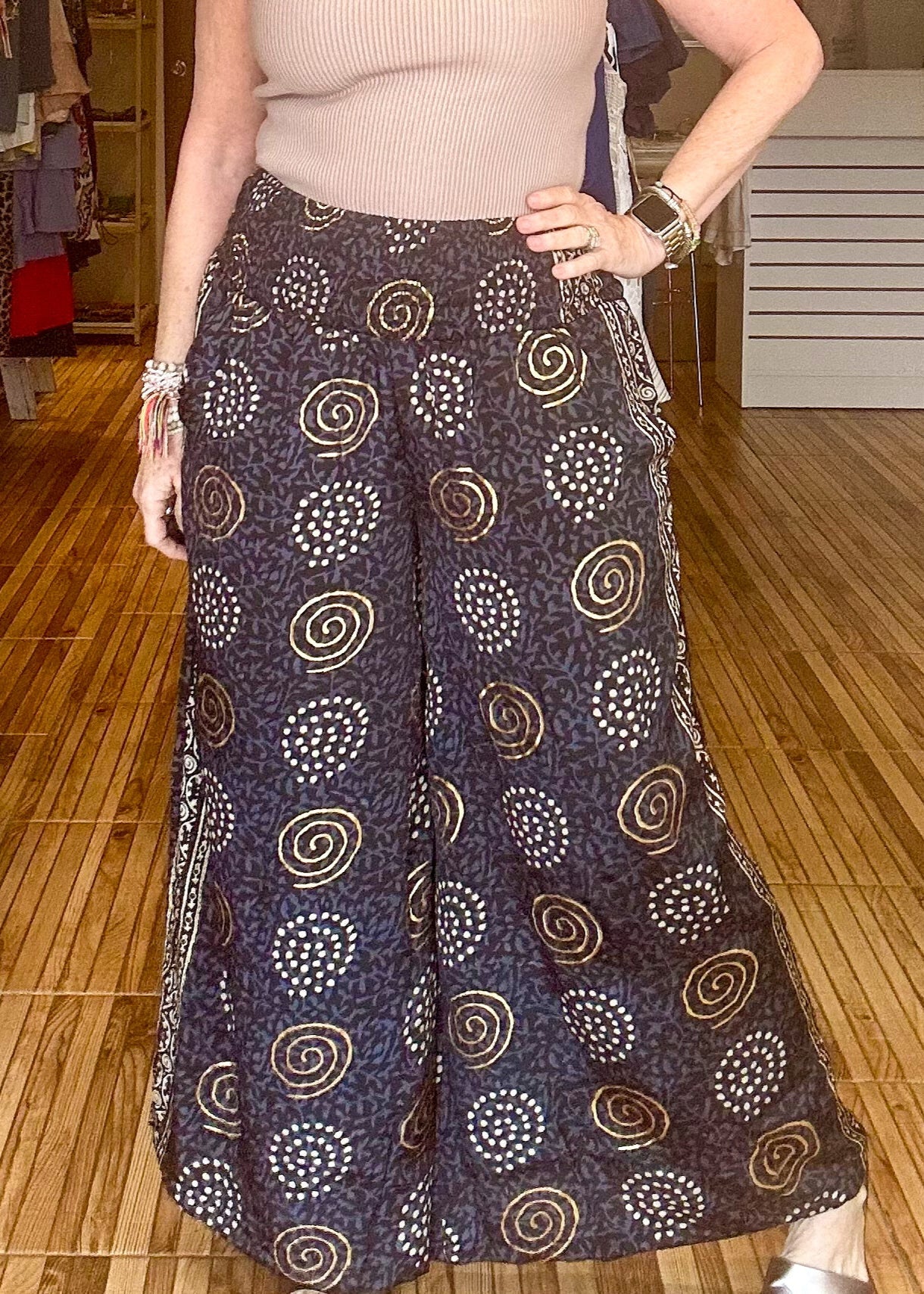 Black and gold printed loose fitting pants with stretch waist.