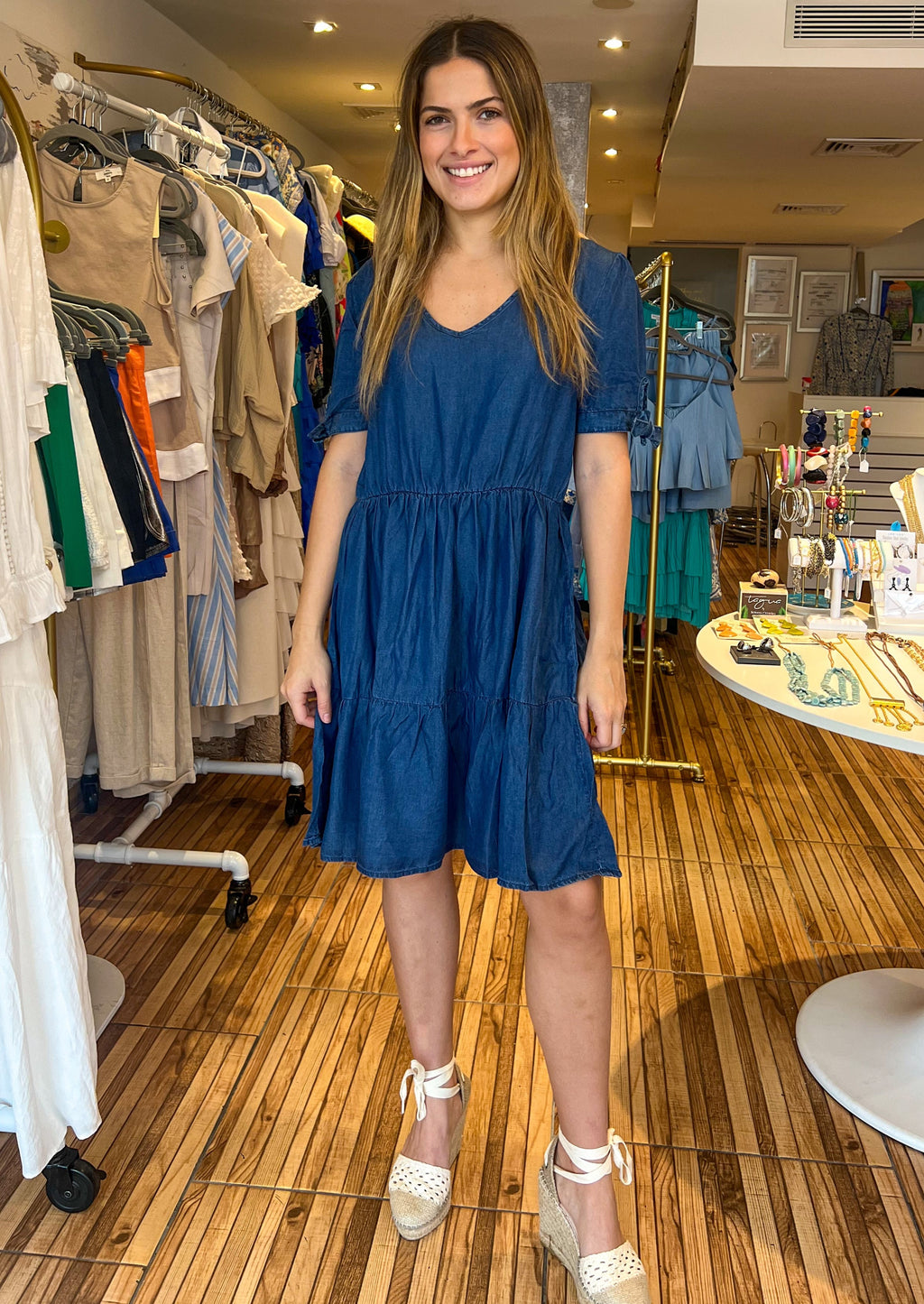Dark denim lyocell chambray tiered short dress with tie at sleeves.