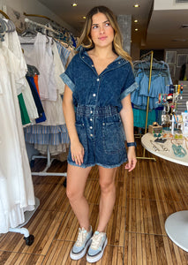 Pocketed button down denim romper with short sleeves and elastic waistband.