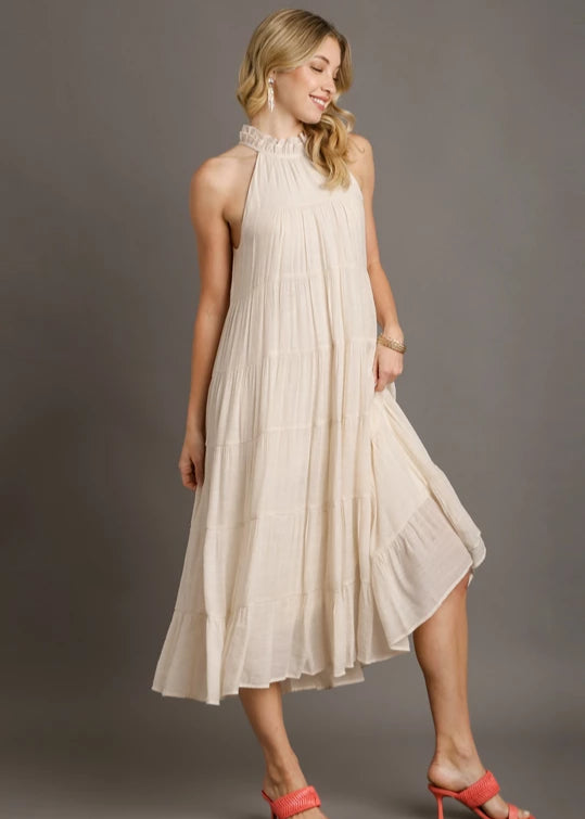 Off white halter neck tiered maxi dress with double layer ruffle trim neckline, back keyhole, tie detail at back with wooden button.