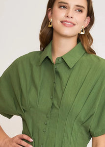 Olive color blocked midi dress with pleated details.