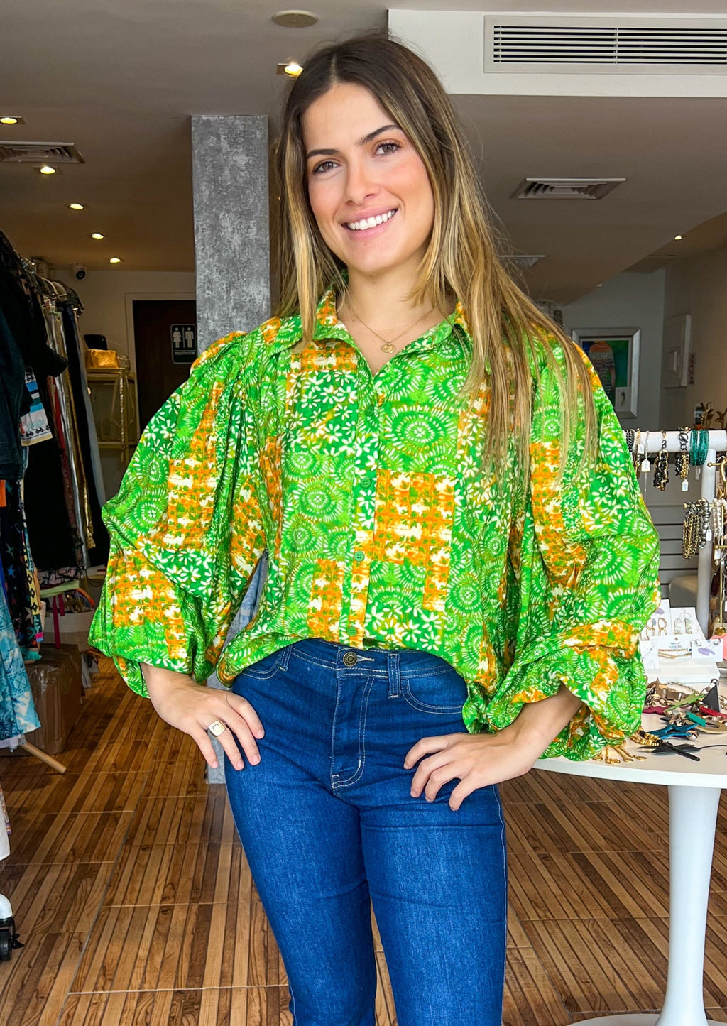 Green and orange printed woven top featuring shirt collar, button down and exaggerated wide sleeve.