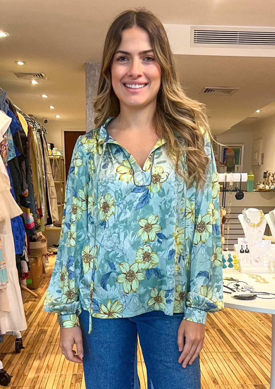 Sage multi floral long sleeve split neck with self tie blouse with buttoned sleeve and ruffled detail on neck.&nbsp;
