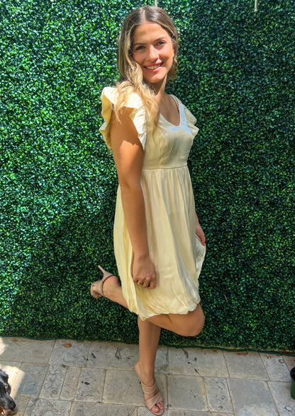 Custard cream scoop front and back short dress. Short ruffle sleeves. Adjusts under the bust. Balloon bottom.