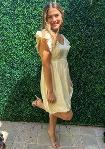 Custard cream scoop front and back short dress. Short ruffle sleeves. Adjusts under the bust. Balloon bottom.