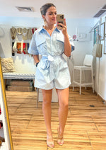 Load image into Gallery viewer, Baby blue button down romper with side pockets and self tie sash.
