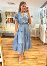 Load image into Gallery viewer, Light dusty blue flutter short sleeves, split neck with tie, con shaped trim tiered midi dress.

