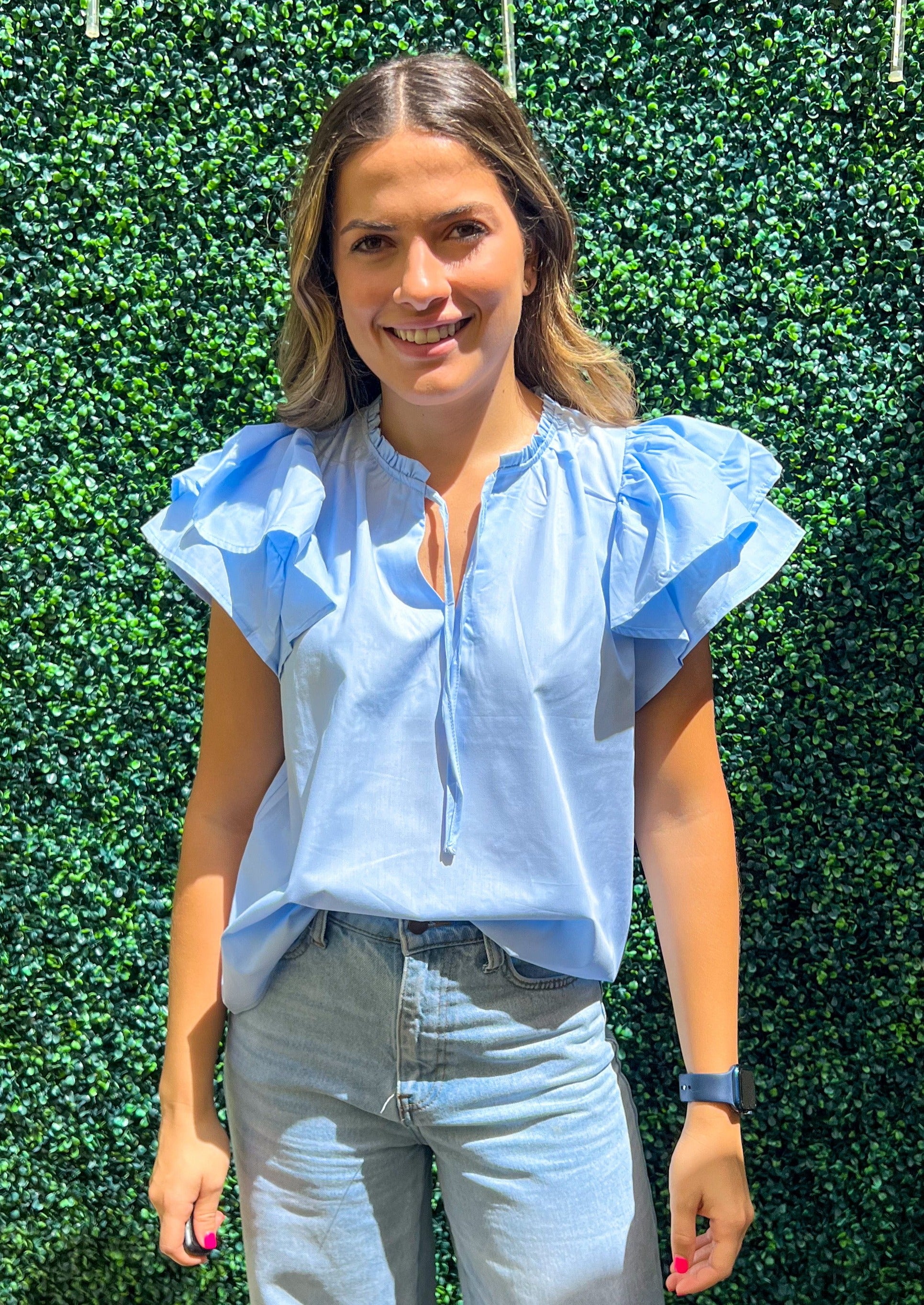 Light blue short flutter sleeve v-neck blouse.