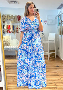 Ivory blue printed woven skirt featuring elasticized waist and tiered skirt. Ivory blue printed woven top featuring surplice neckline, short bell sleeve, side tie and smocked back waist band.