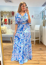 Load image into Gallery viewer, Ivory blue printed woven skirt featuring elasticized waist and tiered skirt. Ivory blue printed woven top featuring surplice neckline, short bell sleeve, side tie and smocked back waist band.
