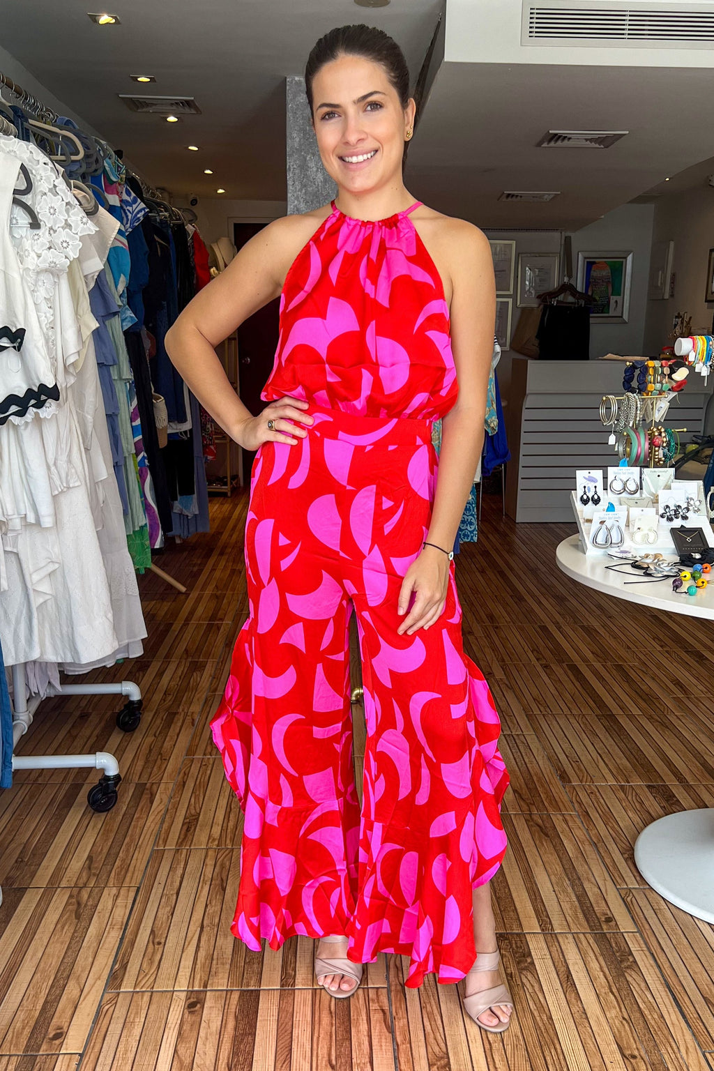 Fuchsia and red color block halter jumpsuit with side slits with ruffle details. Jumpsuit adjusts at the waist. Very flowy and feminine.