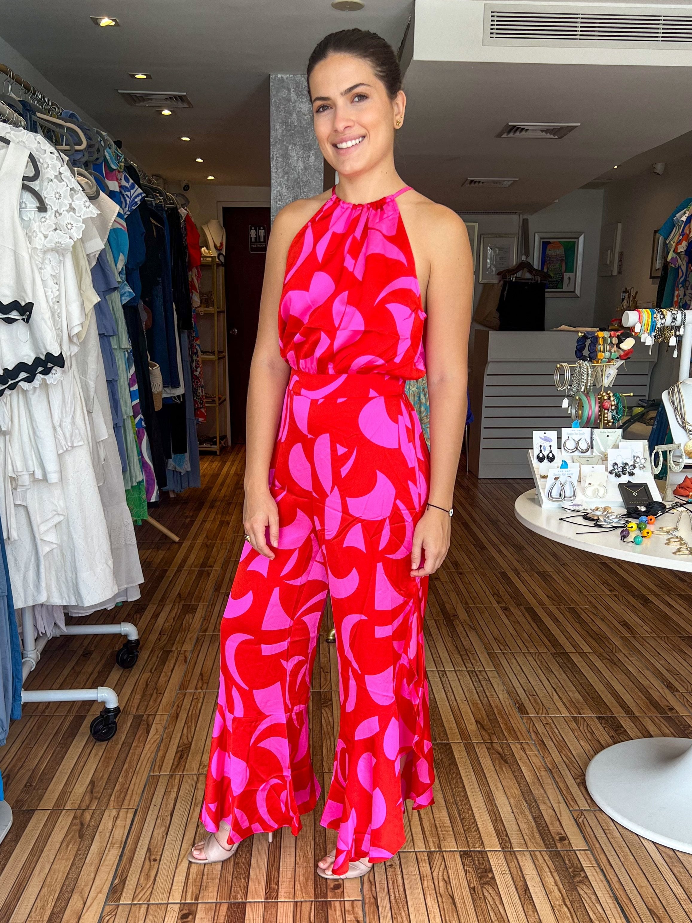 Fuchsia and red color block halter jumpsuit with side slits with ruffle details. Jumpsuit adjusts at the waist. Very flowy and feminine.