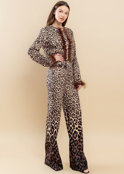 Featuring an all over brown zebra print with ombre design, round neckline, feather trimming as well as a pair of matching pants with a high-rise waist and a wide leg.