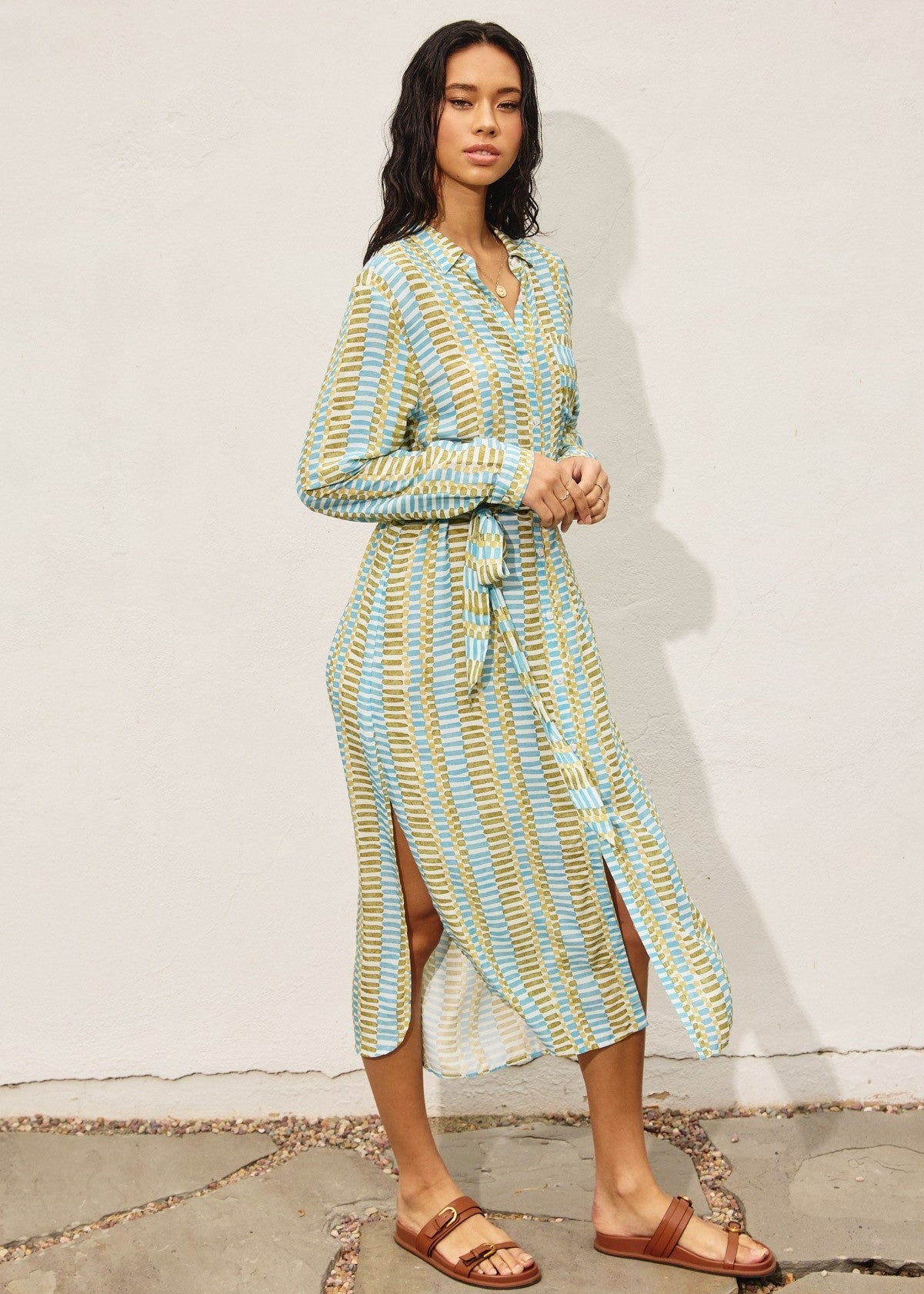 Tropical breeze print longline dress. Features button down closure, side slit detail and side pockets.