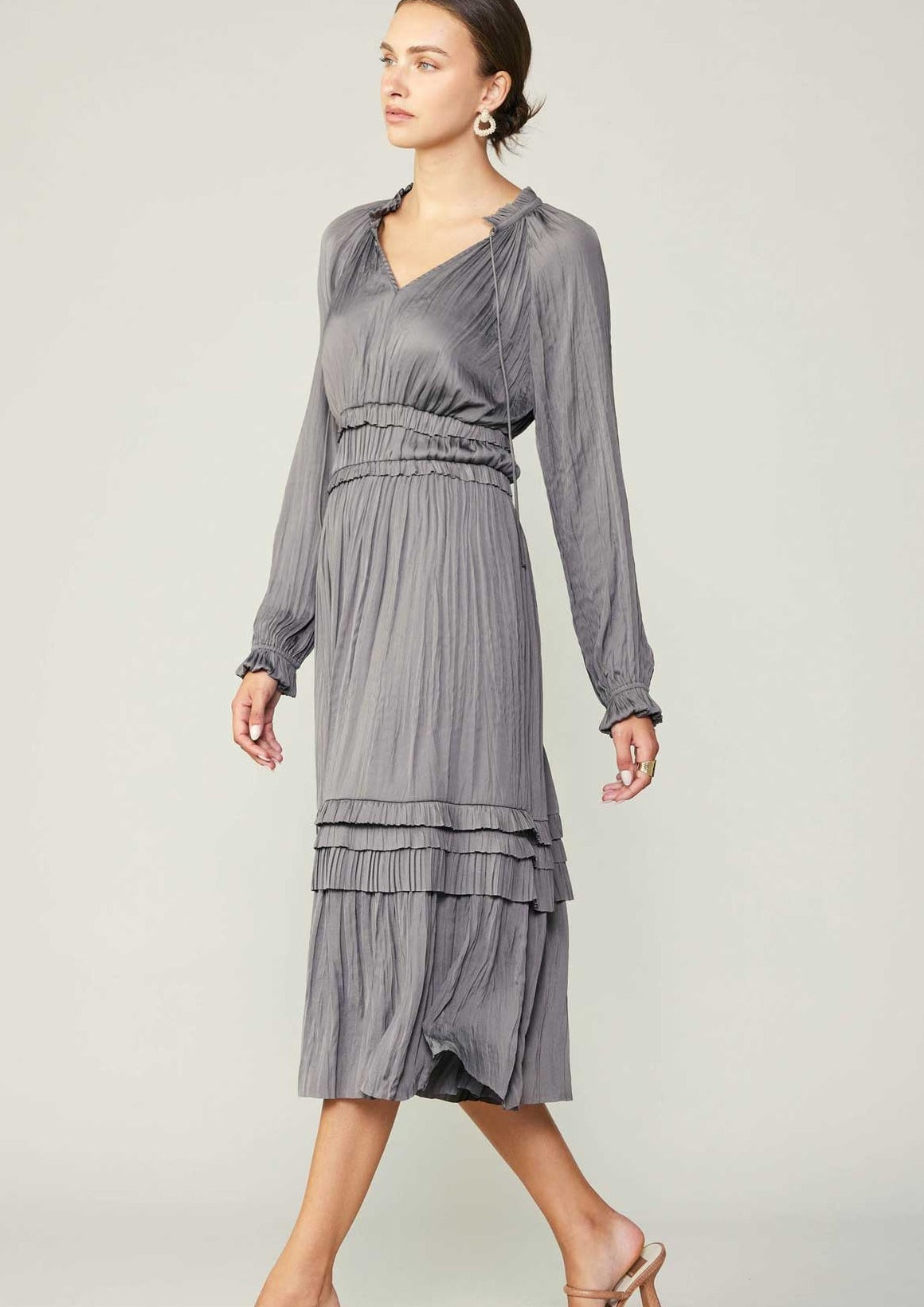 Grey long sleeve split neck long dress with ruffle detail on neck and waist and hem. 