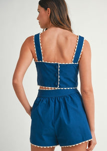 Solid sleeveless floral embroidered detail crop top with back button closure and matching shorts with front button set. Lining.