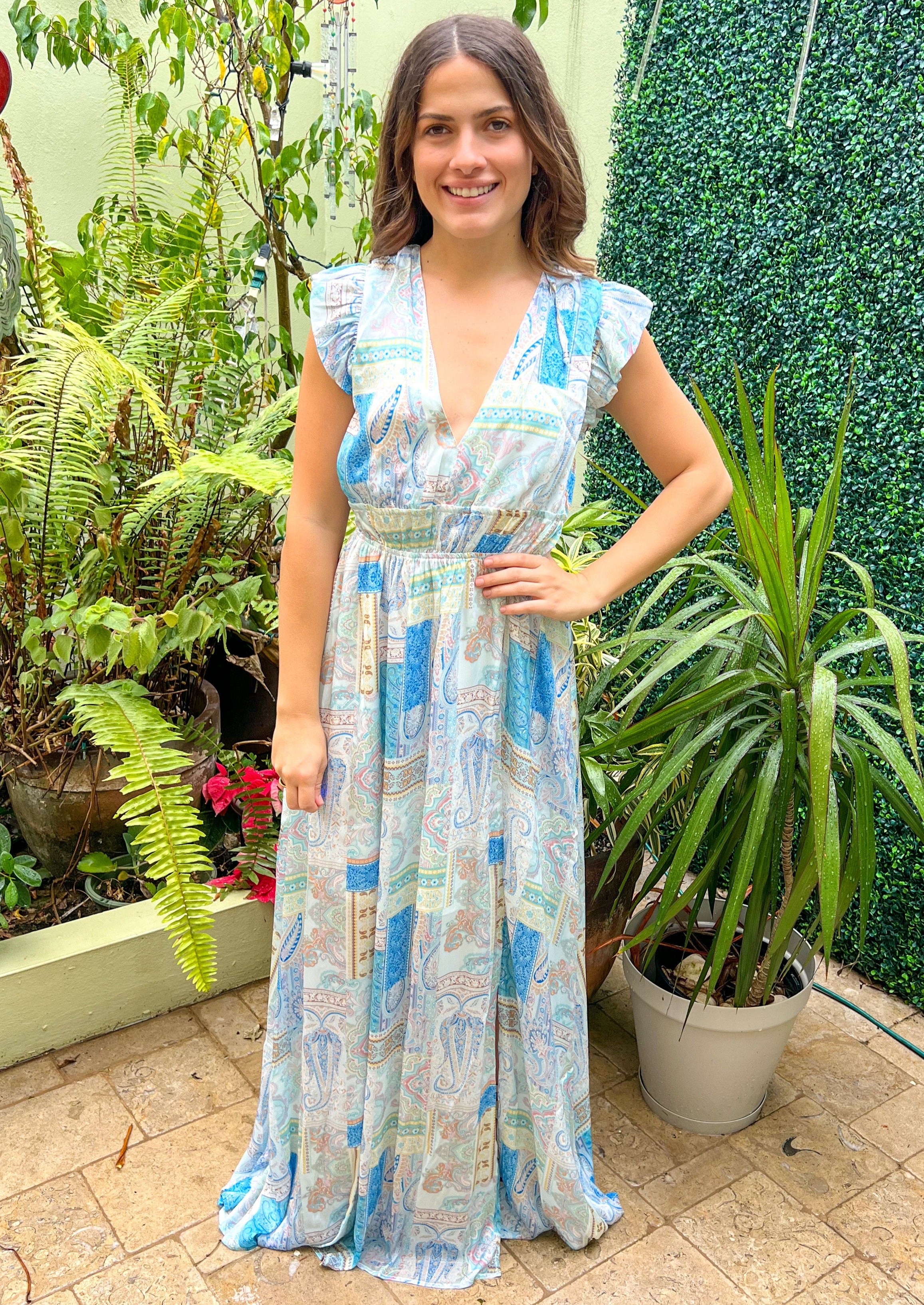 Blue multi paisley print plunged neck maxi dress with a slit on the side. Features lining.