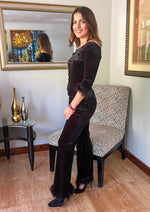 Load image into Gallery viewer, Two piece black suede set with feather details. Feather trim around the 3/4 length sleeve and around the bottom of the pants.
