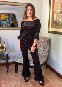 Two piece black suede set with feather details. Feather trim around the 3/4 length sleeve and around the bottom of the pants.